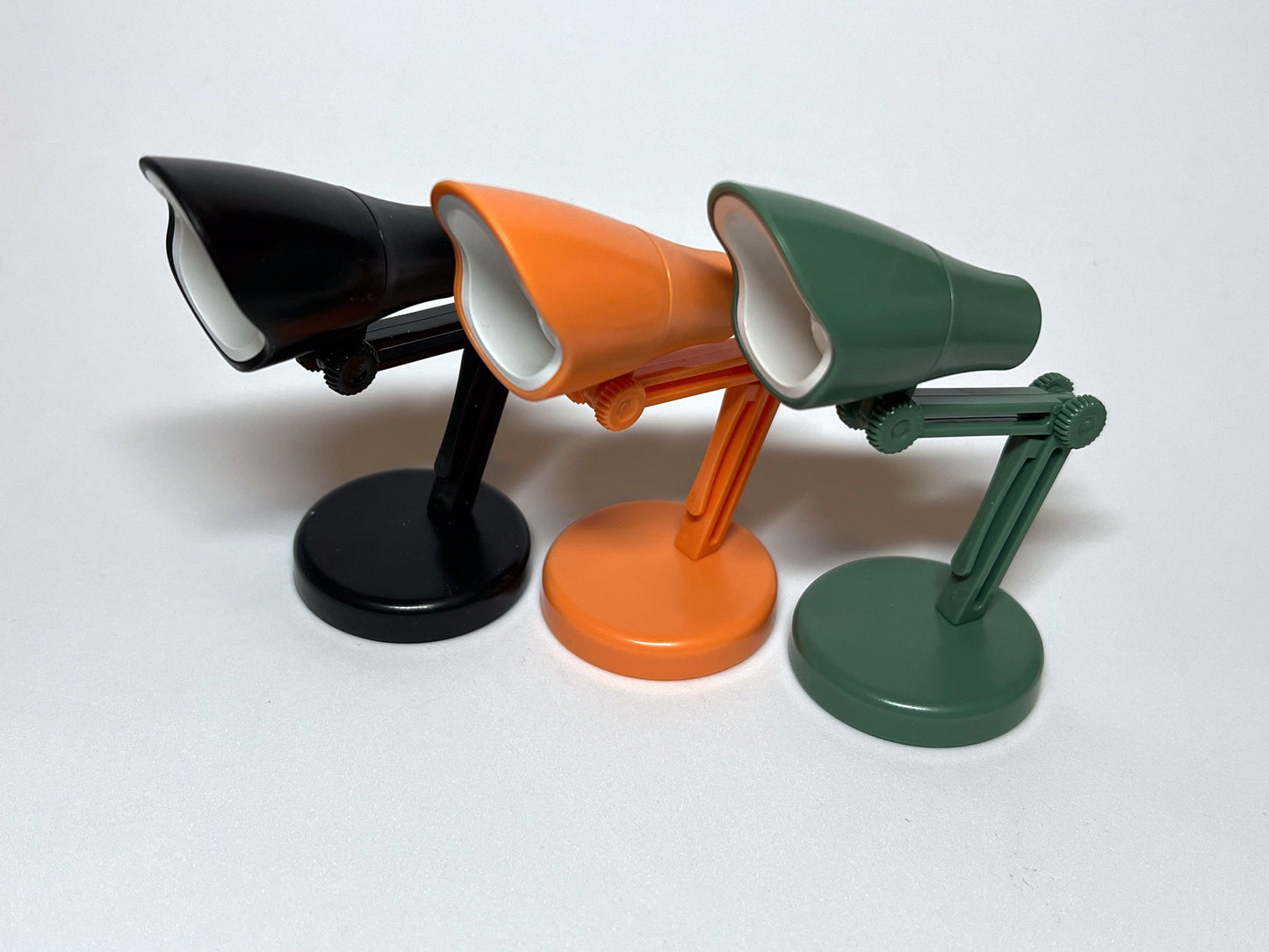 Adorable dollhouse plastic LED folding and portable desk or table lamp. It comes in 3 different colors: orange, green and black. Includes installed batteries plus an extra set, and a foam pad for the bottom to keep it in place. __etsy:5598323195