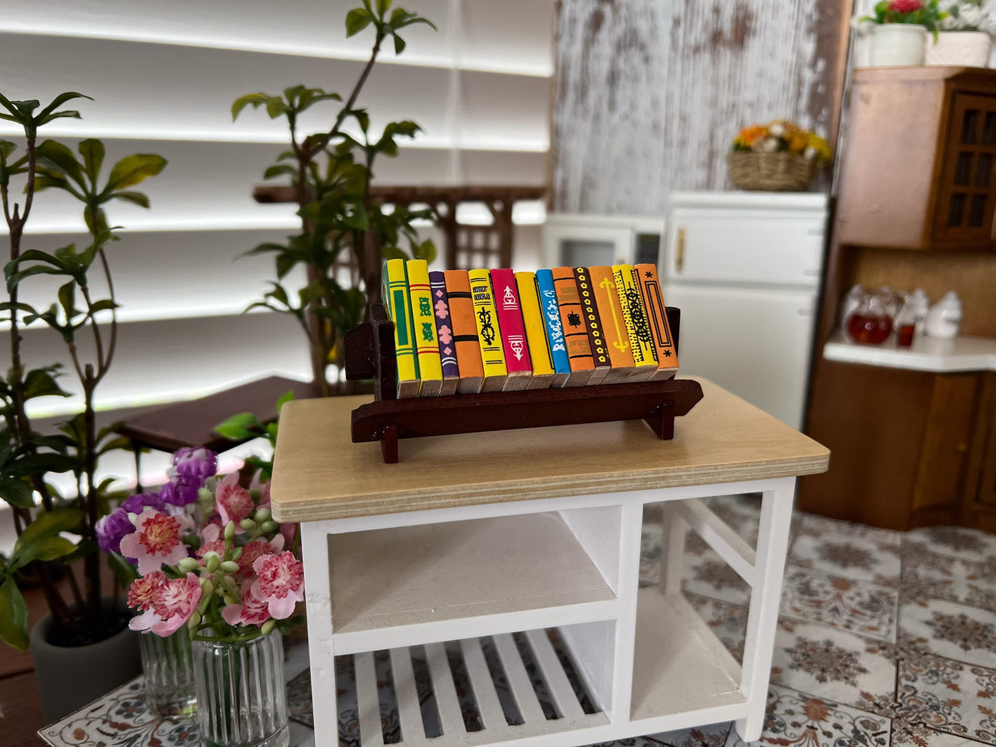 Give your bookworm dolls all the books they will ever need with this miniature bookshelf with books! This stained wood bookshelf features a single shelf that rests in an upward tilt and has thirteen tiny wooden colorful cover books. __etsy:6171729113