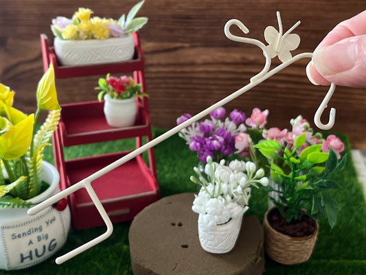 Give your garden space a touch of reality with this wire, beige garden butterfly plant hanger. The piece is versatile, hang potted plants or anything else you desire. It comes with two small hook sections on opposite directions from same pole. __etsy:5776849307