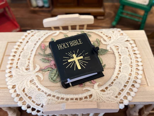 This dollhouse Bible is for 1:12 or 1:6 scales. The book has a rubbery cover with a buckle, and a cross and "Holly Bible imprint in the front in a beautiful gold tone. The number of pages is 200+, it can be open, and it has text. __etsy:5977822771