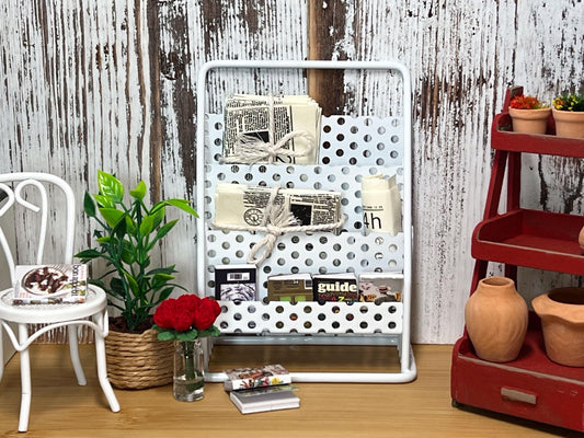 Add an old-world charm to any space in your dollhouse store with this miniature white wrought iron three tier book or newspaper stand. This beautiful stand comes in white and has many realistic details and lots of space. __etsy:6403746502