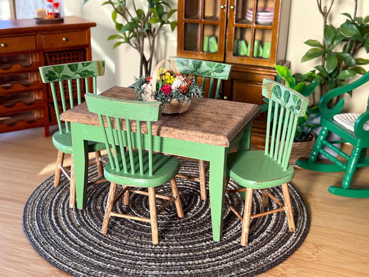 Add a touch of rustic charm to your 1:12 scale dollhouse with this beautifully crafted Green-bottom, Stained-top table and chair set. Each piece is carefully distress-painted and adorned with decoupage paper. __etsy:6613440994