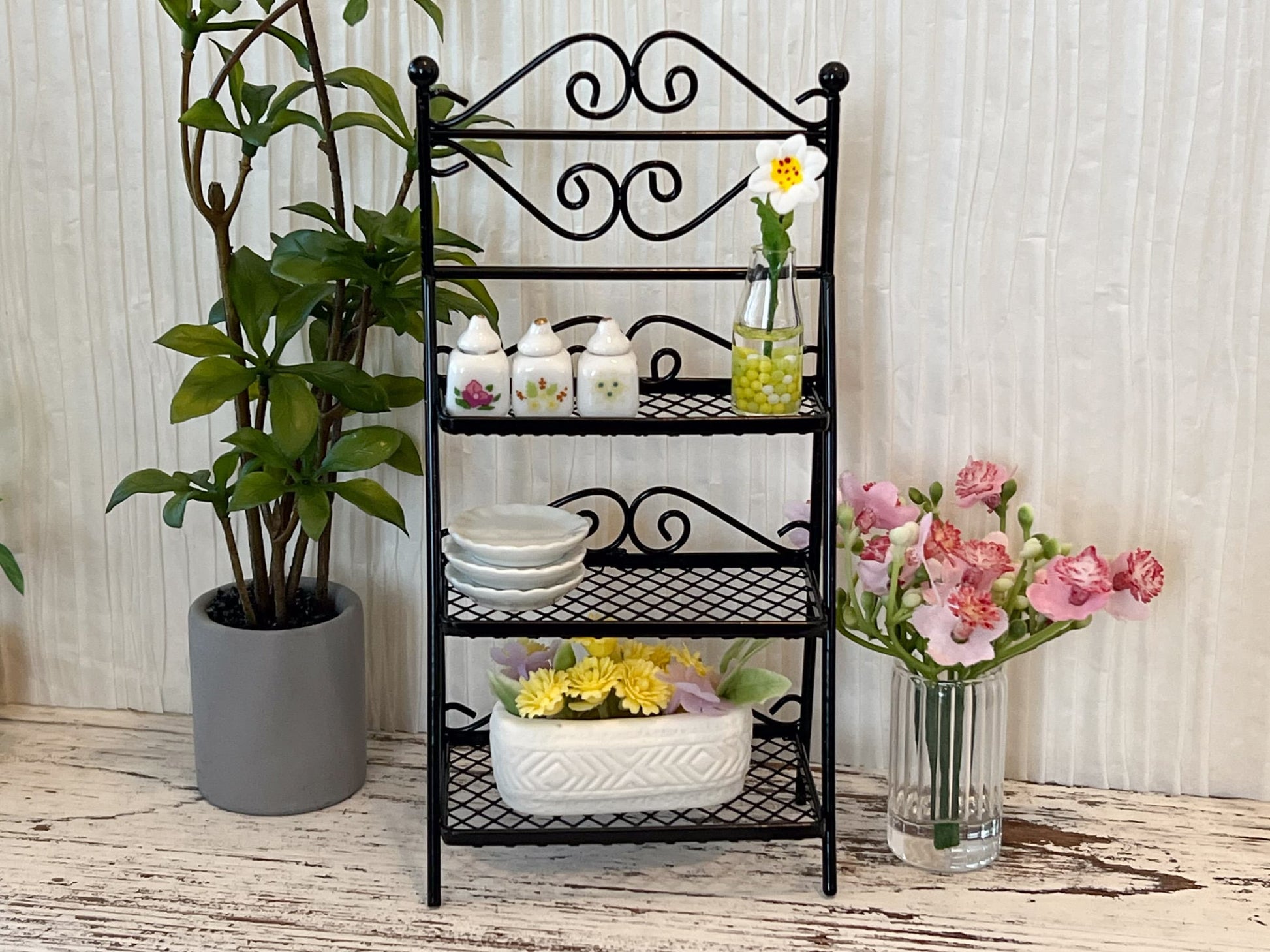 Add an old-world charm to any space in your dollhouse with this miniature wrought iron three tier plant shelf. This beautiful stand comes in black and has many realistic details and lots of space. __etsy:6063079984