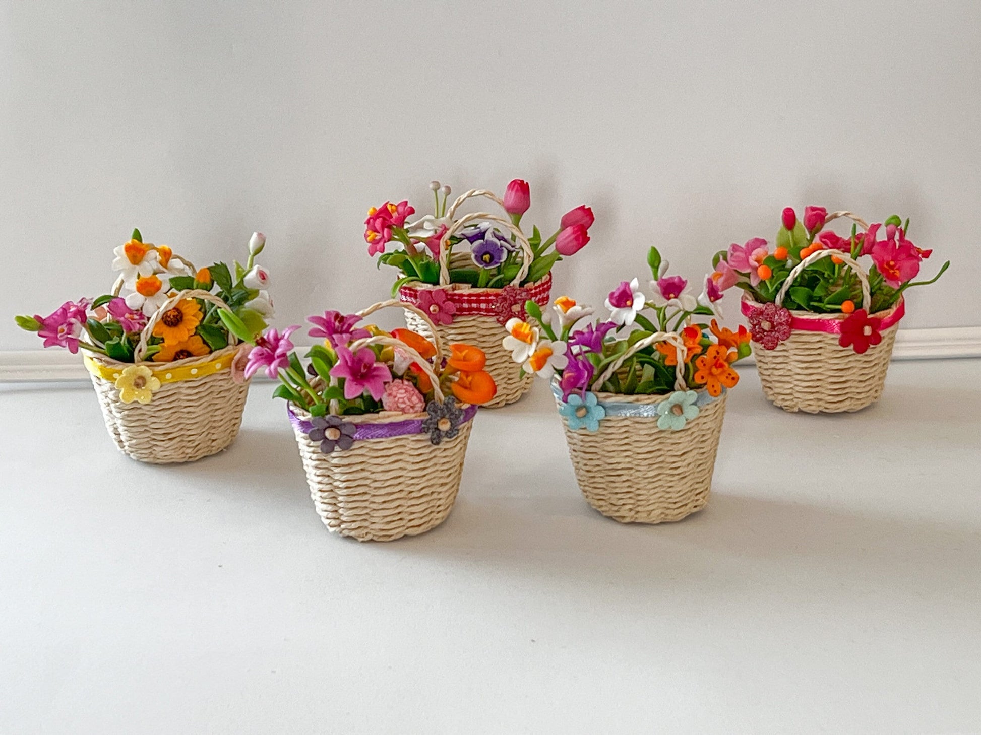 This adorable wicker basket is absolutely beautiful, great miniature dollhouse decor for easter. The basket is decorated with satin lace, cute paper flowers to compliment the look, and with 4 bunches of polymer clay colorful flowers __etsy:6271112498